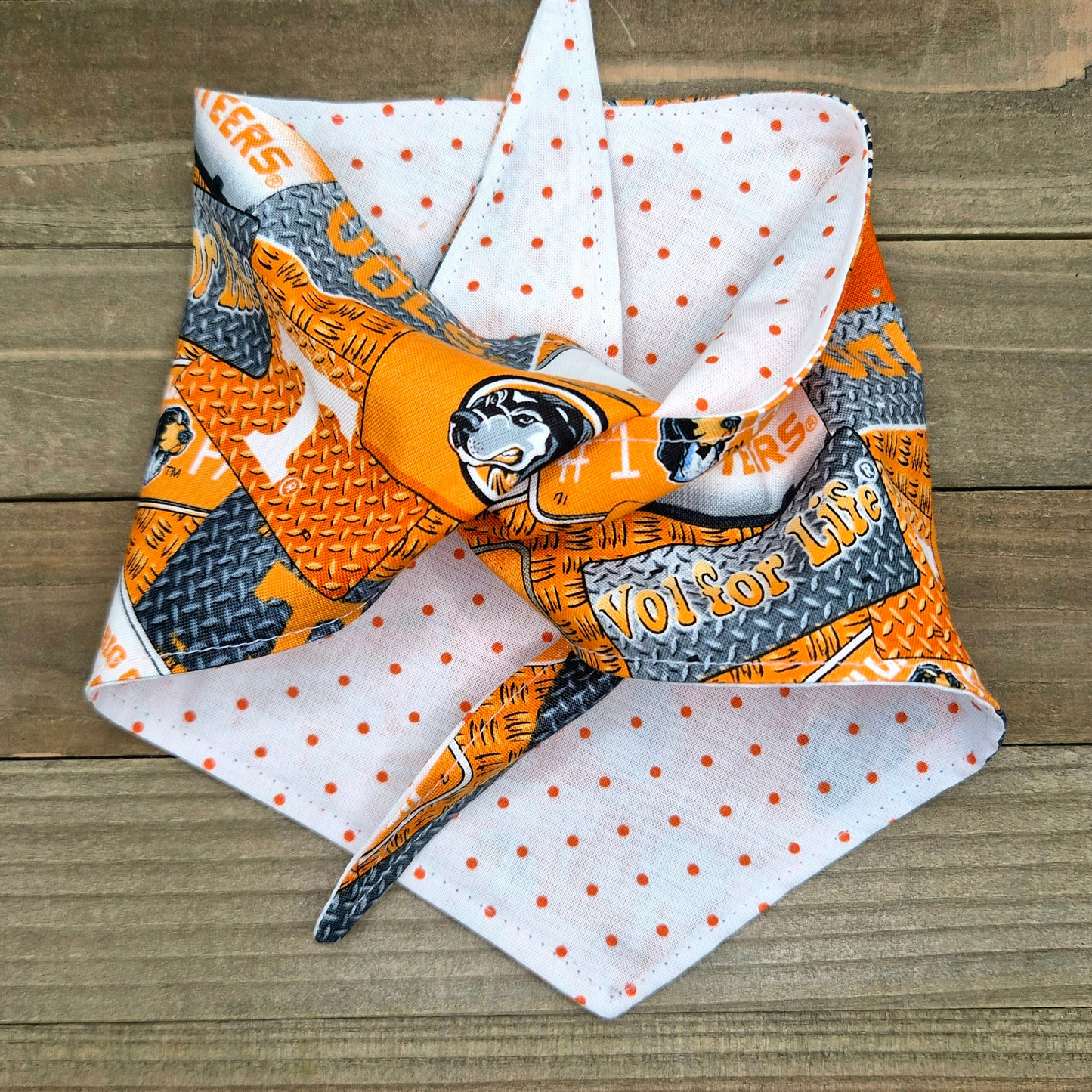 a colorful bandana with a pattern of orange and white polka dots, along with various text and graphics.
