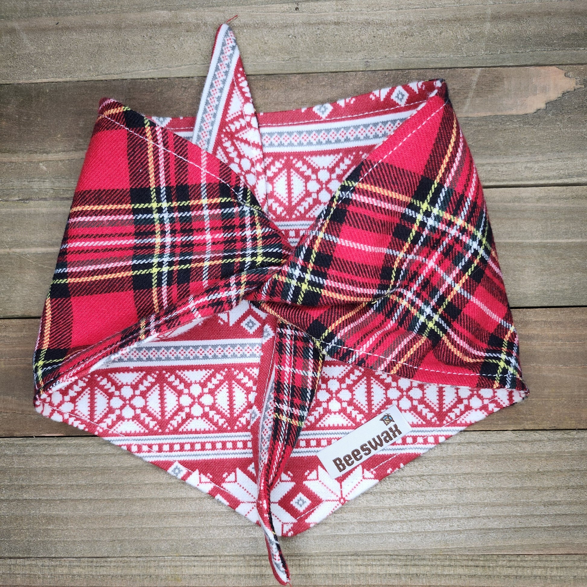 Red and black plaid fabric on a wooden surface