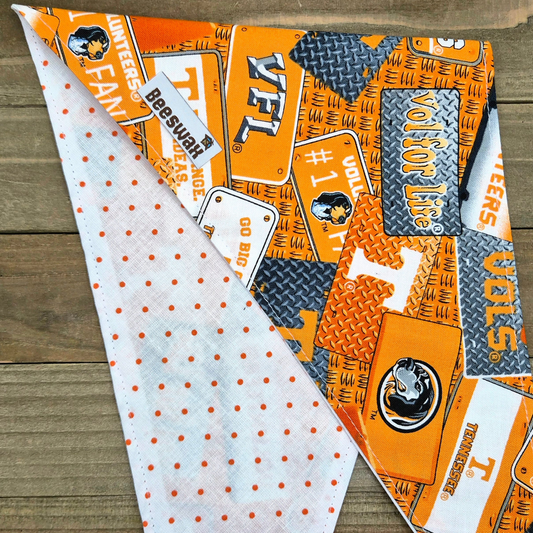 a colorful bandana with various patterns and logos, including the Tennessee Titans logo, printed on a wooden surface.
