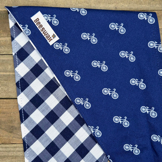 a blue fabric with white bicycle patterns, and there is a white and blue checkered fabric on the left side.