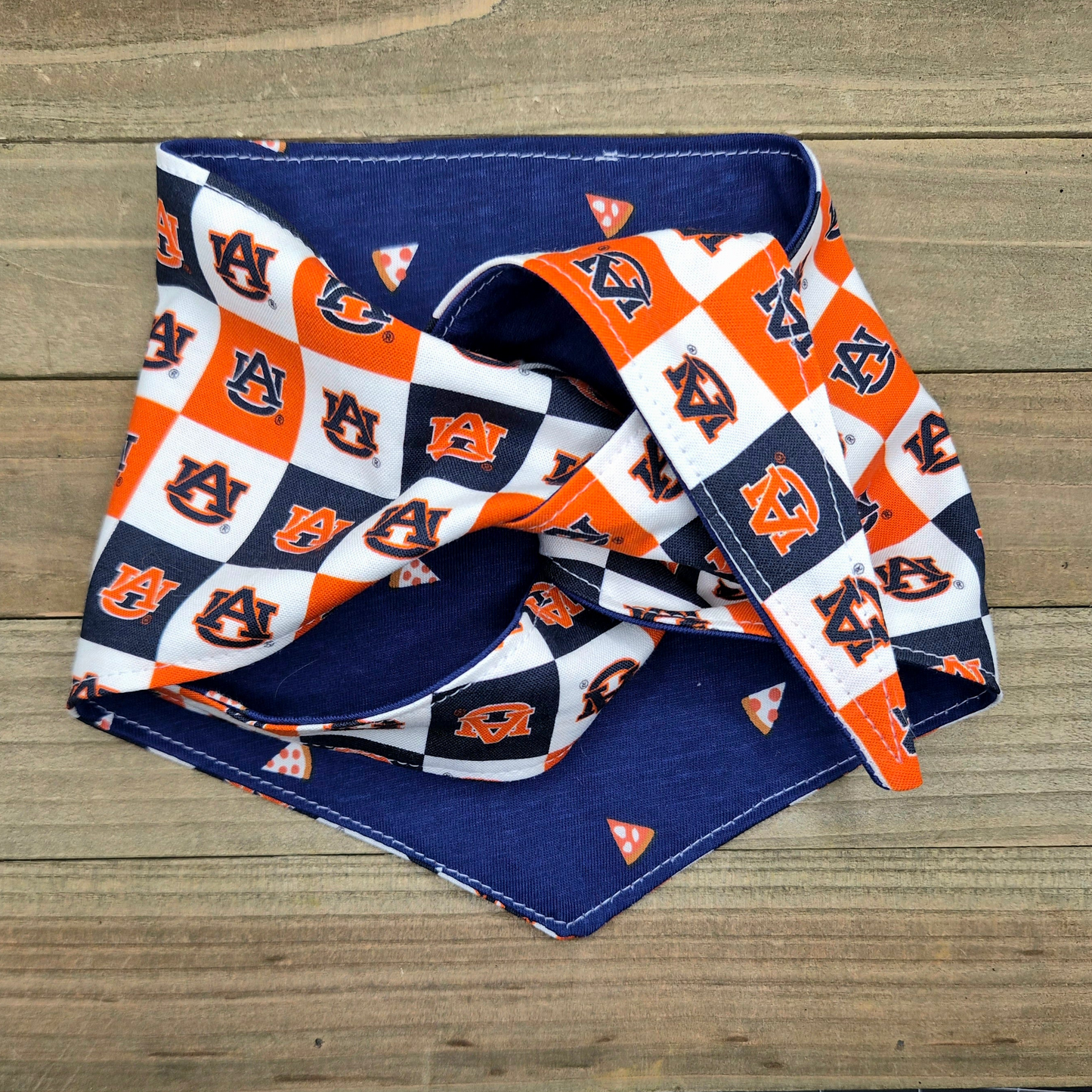 a blue and orange patterned bandana with the Auburn University logo, which is a sports team.
