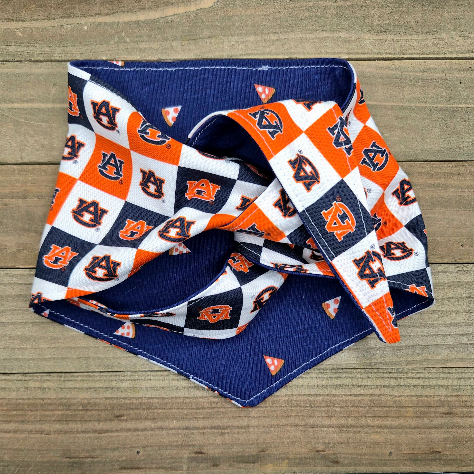 a blue and orange patterned bandana with the Auburn University logo, which is a sports team.