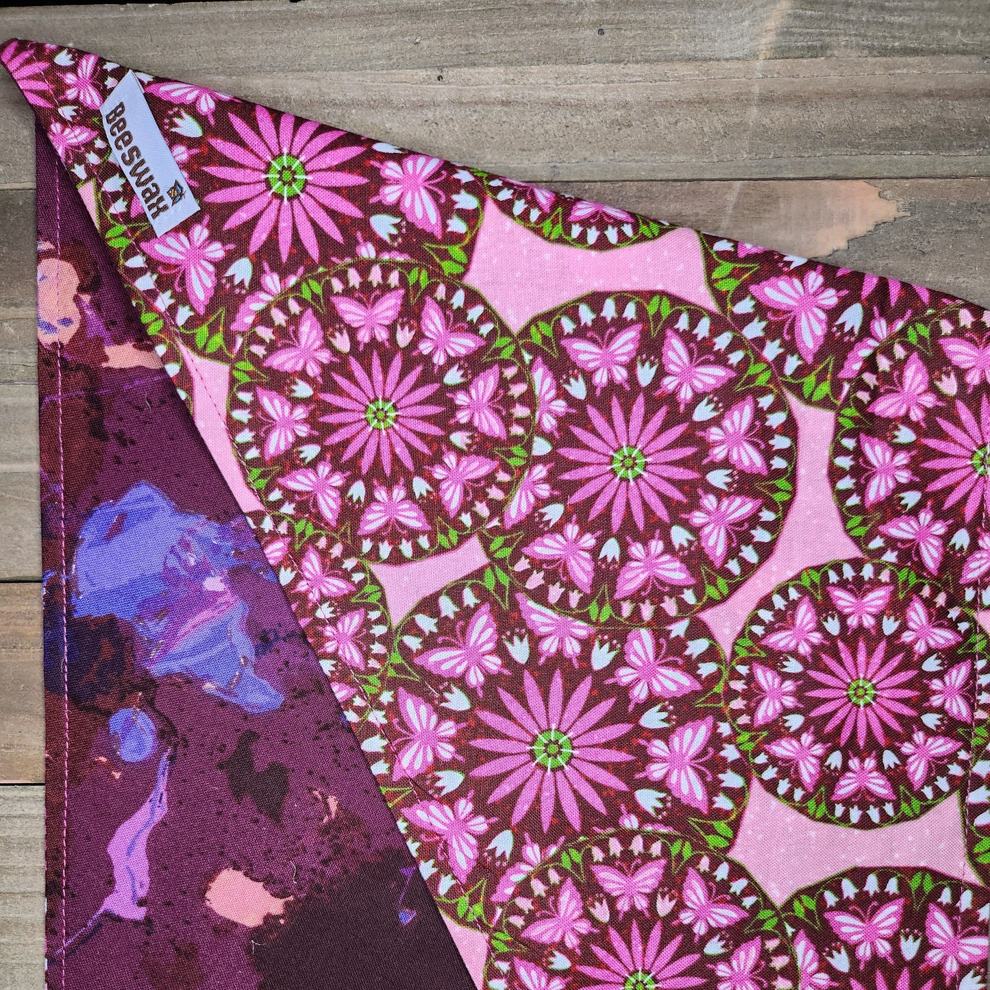 Fabric with pink floral pattern on a wooden surface