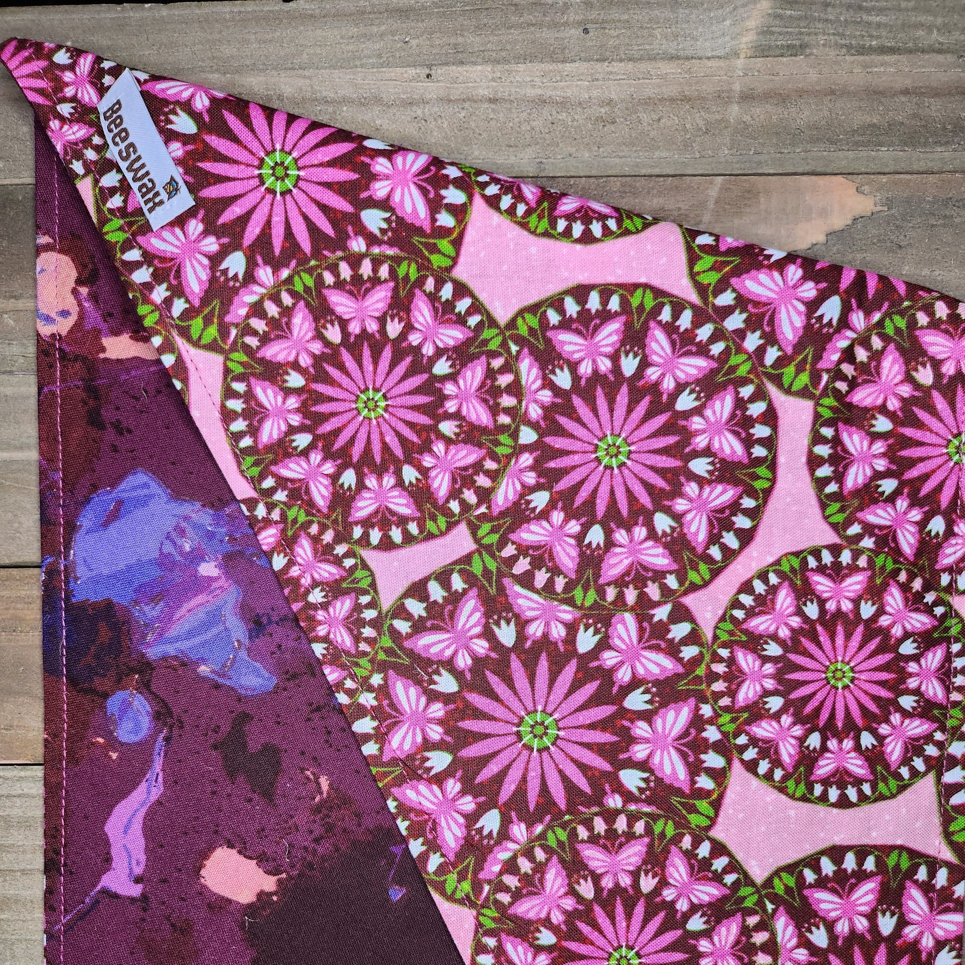 Fabric with pink floral pattern on a wooden surface