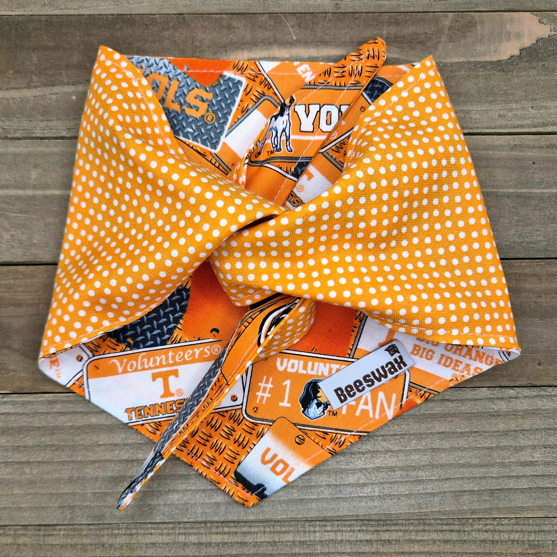 a colorful bandana with various text and graphics, including the word "Volunteers" and the Tennessee Titans logo.